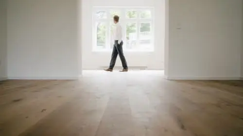 Businessman walking in empty flat